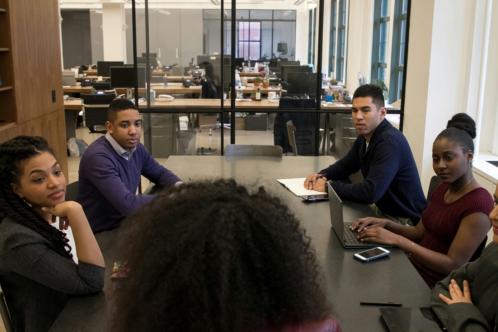 Diverse youth including black students engaging with technology